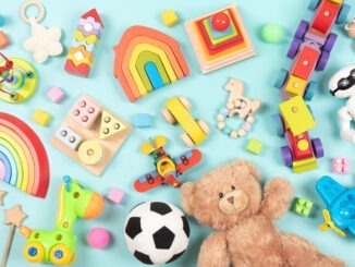 Baby kids toys pattern. Set of colorful educational wooden and fluffy toys for children on light blue background. Top view, flat lay.