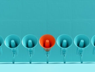 Important announcement, attention and different message concept. Blue megaphones in a row with one of them is in orange color on blue background. 3D render.