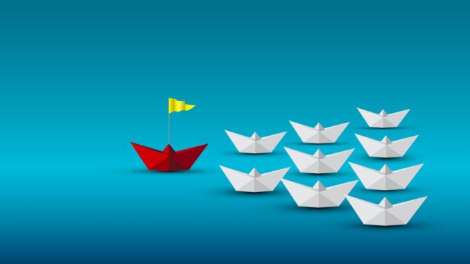 Red paper boat with yellow flag leading white boats on blue background represents leadership, success, vision, innovation, confidence, teamwork in business, strategy, and creative management concept.