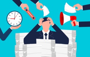 Heavy workload, overloaded with stress. Multi-tasking businessman sitting with his hands on his head in a file