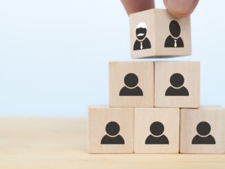 business hand man put arranging on wooden cube block that family or company Succession business concept from old generation to next generation.