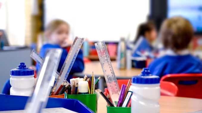 School classroom scene with kids learning in background
