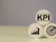KPI Measurement for Business Success key Indicators to Track Goals and Performance on wood label. Marketing strategies, realistic objectives, and controlled planning for optimal results.