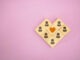 Wooden blocks forming people around a heart symbol, representing community, connection, love, and emotional support.