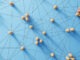 Social media networking. Network with members connected with each other. Group of people. Communication, teamwork, community, society. Abstract concept with wooden pieces on blue background.