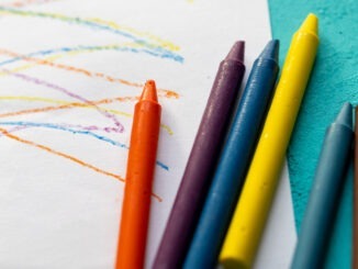 A close-up image of colorful pastel crayons placed on a clean white paper surface. The vibrant textures and pigments of the pastels highlight their artistic potential, making this scene perfect for educational, creative, and artistic-themed content. Ideal for stock use in art tutorials, school materials, or DIY projects.