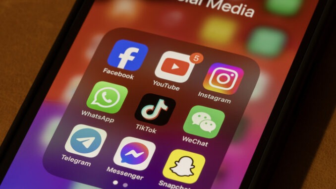 Portland, OR, USA - Nov 11, 2024: Some of the most popular social media apps by number of monthly active users, including Facebook, YouTube, Instagram, WhatsApp, TikTok, WeChat, Telegram, Messenger, and Snapchat, are seen on an iPhone.