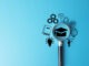E-learning and online education concept. A magnifying glass focuses on a graduation cap surrounded by icons for study, knowledge, and digital courses, representing modern skill development.